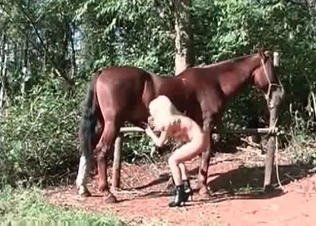 Farm girl is blowing a horse